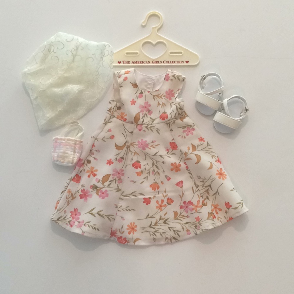Three American Girl Doll Outfits, and hangers.